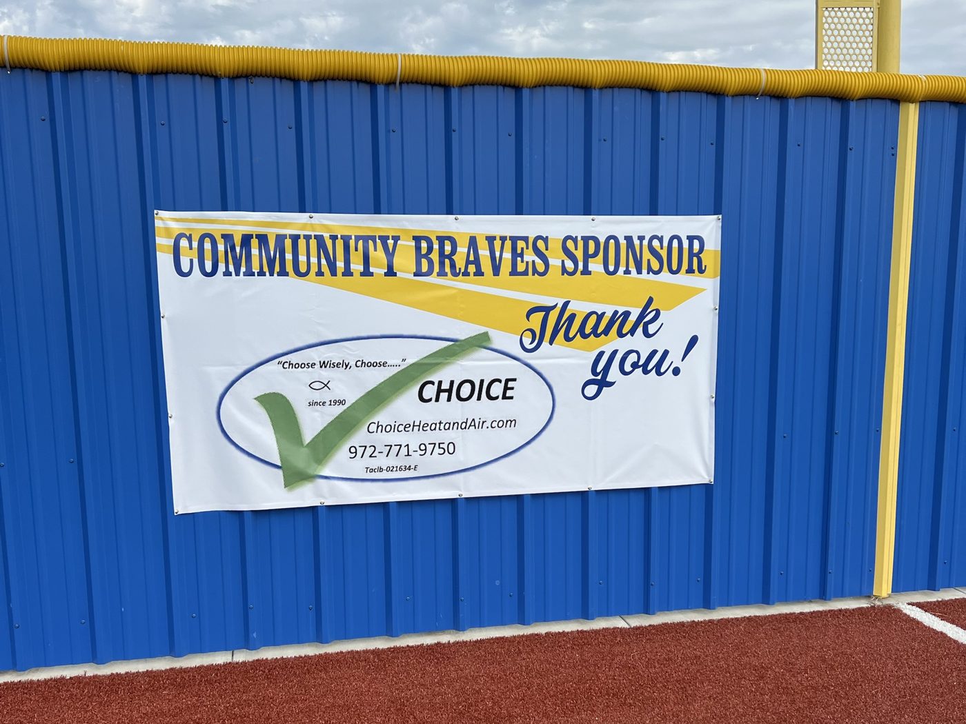 Choice Heating and Air Conditioning sponsor banner on the Community Braves outfield wall