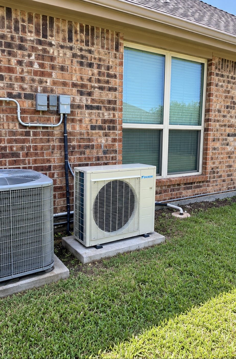 New Daikin outdoor unit installed next to an existing AC unit